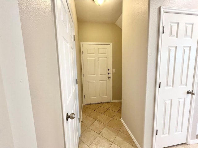 139 Diamondback Cv, Buda, TX 78610 - hall featuring light tile patterned floors and baseboards
