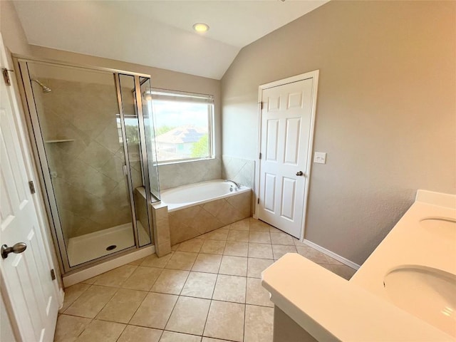 139 Diamondback Cv, Buda, TX 78610 - bathroom with lofted ceiling, tile patterned floors, a garden tub, a shower stall, and double vanity