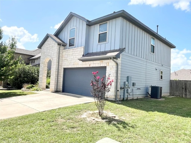 139 Diamondback Cv, Buda, TX 78610 - view of home's exterior featuring board and batten siding, an attached garage, stone siding, and driveway