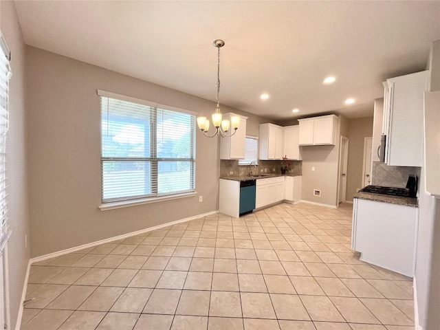 139 Diamondback Cv, Buda, TX 78610 - kitchen featuring dishwashing machine, dark countertops, tasteful backsplash, a chandelier, and light tile patterned floors