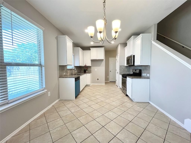 139 Diamondback Cv, Buda, TX 78610 - kitchen featuring stainless steel appliances, a chandelier, decorative backsplash, and light tile patterned flooring