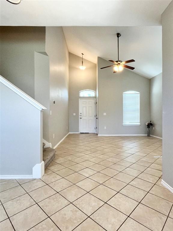 139 Diamondback Cv, Buda, TX 78610 - unfurnished living room featuring stairway, light tile patterned floors, a ceiling fan, and high vaulted ceiling