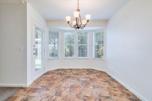 233 Sunshadow Dr, Lockhart, TX 78644 - unfurnished dining area featuring a chandelier and stone finish floors