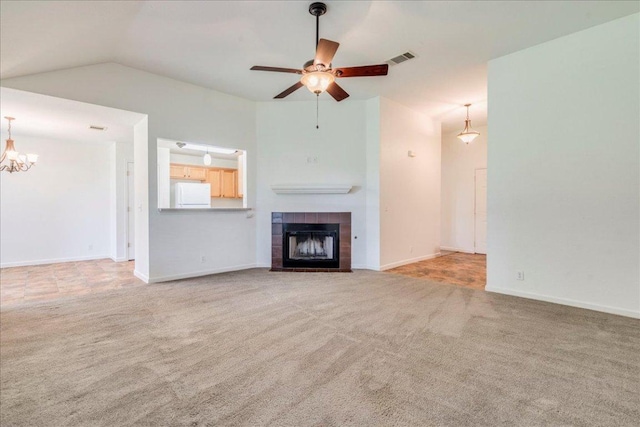 233 Sunshadow Dr, Lockhart, TX 78644 - unfurnished living room featuring carpet flooring, a tiled fireplace, ceiling fan, a chandelier, and lofted ceiling