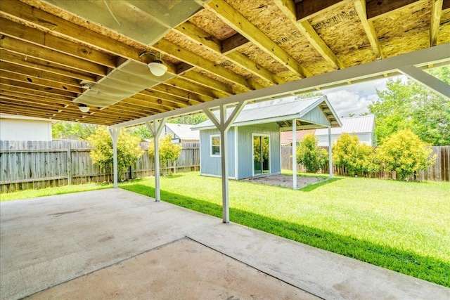 233 Sunshadow Dr, Lockhart, TX 78644 - fenced backyard with a patio area and an outbuilding