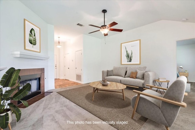 233 Sunshadow Dr, Lockhart, TX 78644 - living area with a ceiling fan, carpet flooring, a tile fireplace, and lofted ceiling