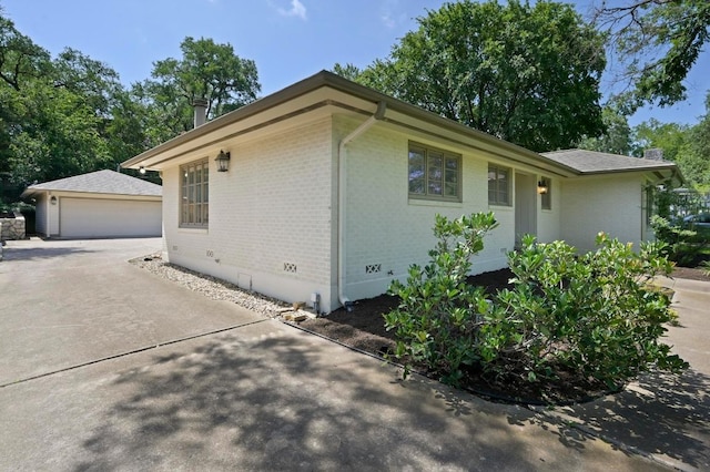2507 Hartford Rd, Austin, TX 78703 - view of property exterior featuring brick siding, an outdoor structure, crawl space, and a garage