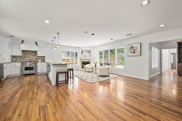 2507 Hartford Rd, Austin, TX 78703 - living room with light wood finished floors, recessed lighting, and a fireplace