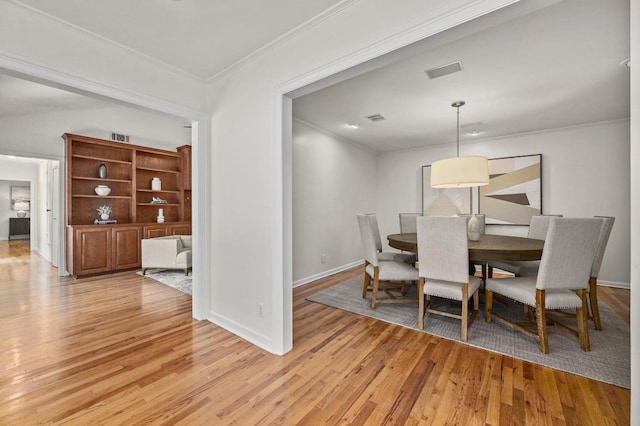 2507 Hartford Rd, Austin, TX 78703 - dining space with crown molding and light wood-style floors