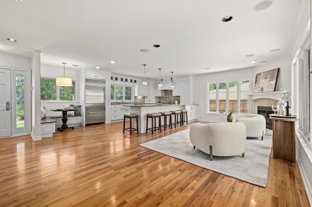2507 Hartford Rd, Austin, TX 78703 - living area with light wood-type flooring, plenty of natural light, a tiled fireplace, and recessed lighting