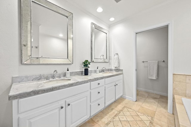 2507 Hartford Rd, Austin, TX 78703 - bathroom featuring double vanity, a relaxing tiled tub, tile patterned floors, recessed lighting, and crown molding