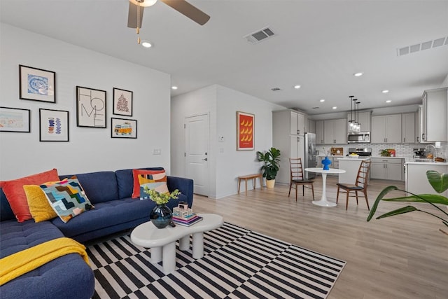 13506 Grand Central Dr, Pflugerville, TX 78660 - living area featuring light wood-style floors, recessed lighting, and ceiling fan