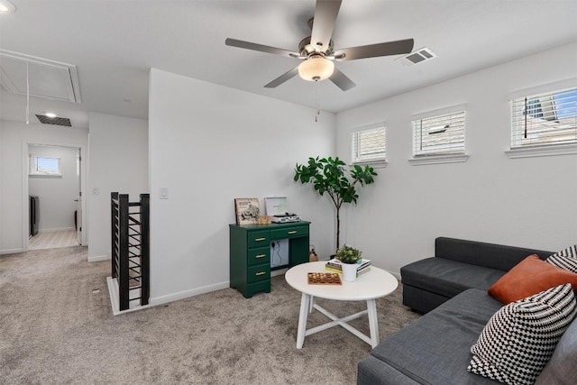 13506 Grand Central Dr, Pflugerville, TX 78660 - living room with attic access, healthy amount of natural light, light carpet, and a ceiling fan
