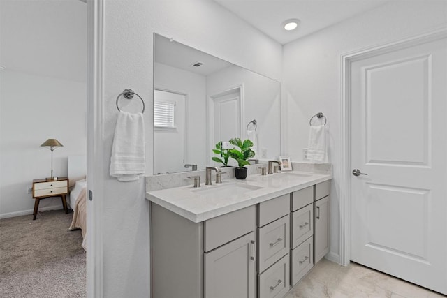 13506 Grand Central Dr, Pflugerville, TX 78660 - ensuite bathroom with double vanity and baseboards