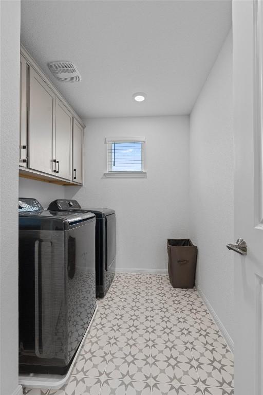 13506 Grand Central Dr, Pflugerville, TX 78660 - laundry area with tile patterned floors, independent washer and dryer, and cabinet space