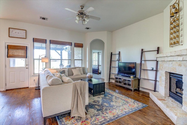 5521 Texas Bluebell Dr, Spicewood, TX 78669 - living area with plenty of natural light, arched walkways, a ceiling fan, and a stone fireplace