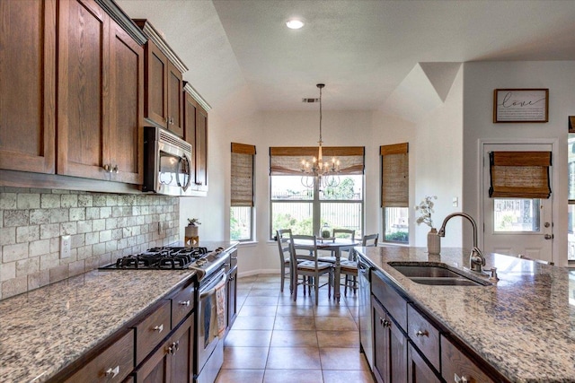 5521 Texas Bluebell Dr, Spicewood, TX 78669 - kitchen featuring stainless steel appliances, healthy amount of natural light, light stone countertops, tasteful backsplash, and lofted ceiling