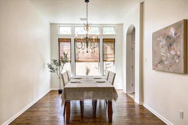 5521 Texas Bluebell Dr, Spicewood, TX 78669 - dining room with a chandelier, dark wood finished floors, and arched walkways