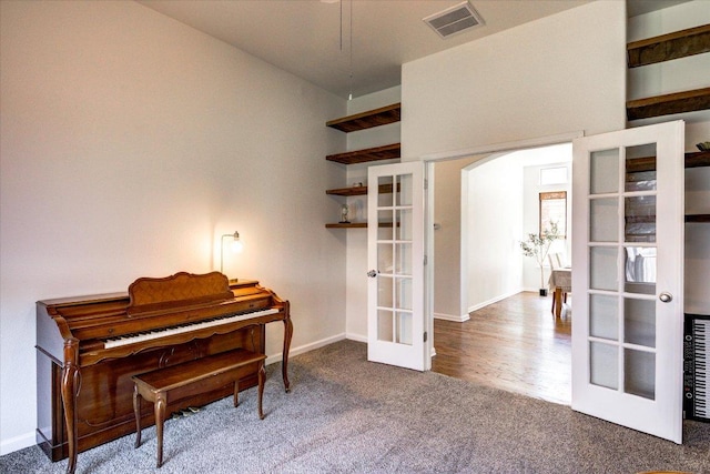 5521 Texas Bluebell Dr, Spicewood, TX 78669 - living area featuring french doors, carpet flooring, and arched walkways