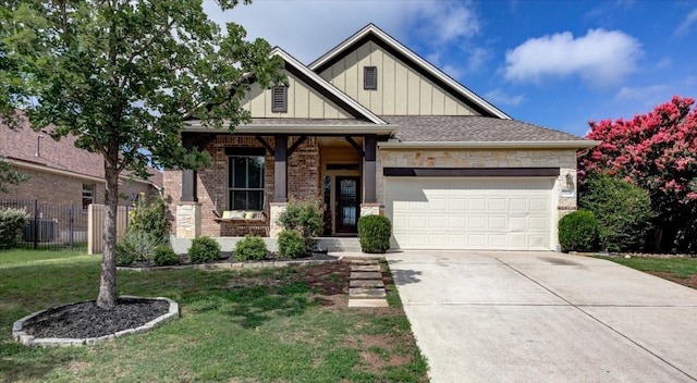 5521 Texas Bluebell Dr, Spicewood, TX 78669 - craftsman-style house with board and batten siding, an attached garage, concrete driveway, stone siding, and brick siding