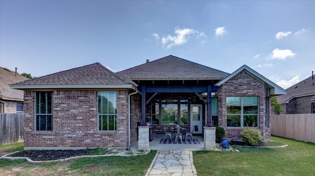 5521 Texas Bluebell Dr, Spicewood, TX 78669 - rear view of house featuring brick siding, a patio area, and roof with shingles