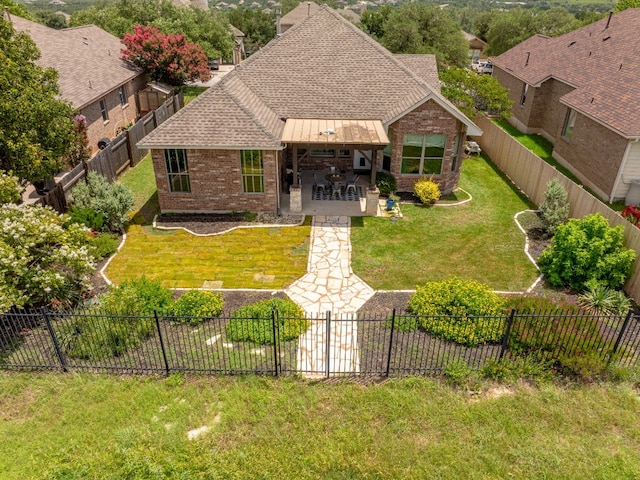 5521 Texas Bluebell Dr, Spicewood, TX 78669 - view of front of home with brick siding, a standing seam roof, a patio area, a fenced backyard, and a shingled roof