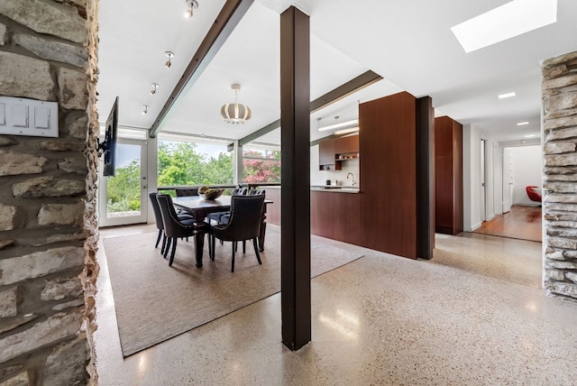 1200 Redbud Trl, West Lake Hills, TX 78746 - dining room with dark speckled floor and a skylight