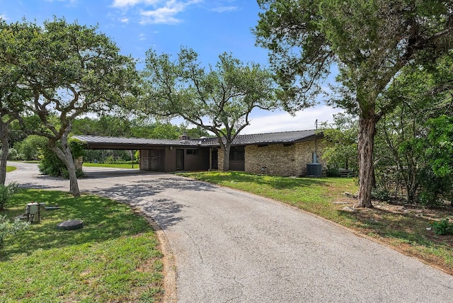1200 Redbud Trl, West Lake Hills, TX 78746 - view of front of house with an attached carport, asphalt driveway, a front lawn, and a metal roof