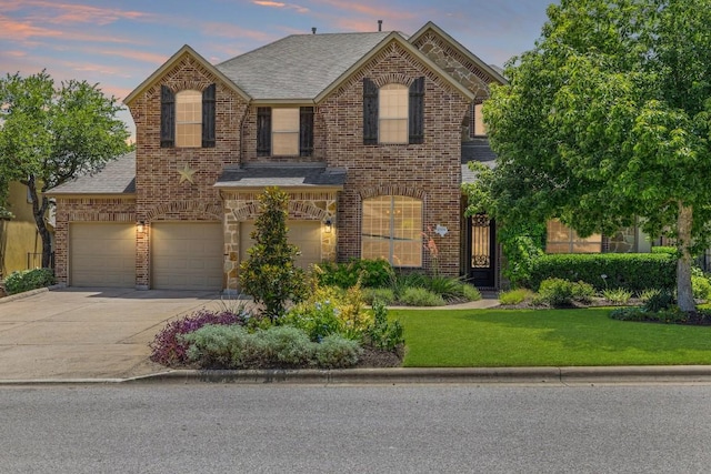 8709 Fescue Ln, Austin, TX 78738 - view of front of house featuring driveway, brick siding, a yard, roof with shingles, and an attached garage