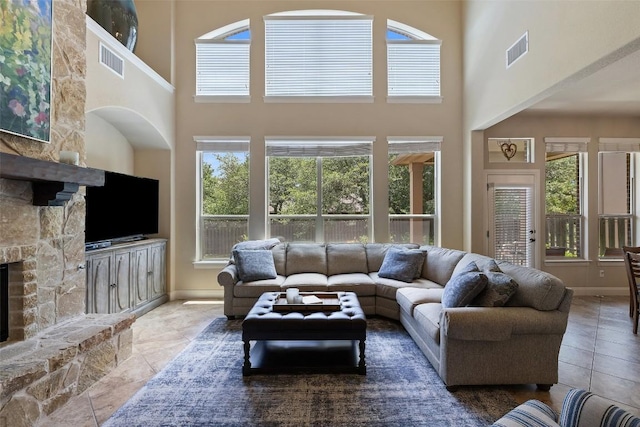 8709 Fescue Ln, Austin, TX 78738 - tiled living area with a stone fireplace and a towering ceiling