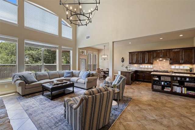 8709 Fescue Ln, Austin, TX 78738 - living room featuring a chandelier, a towering ceiling, and light tile patterned flooring
