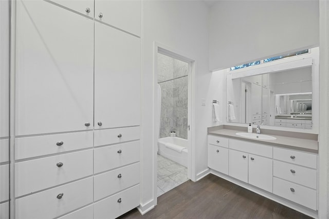 2909 Stratford Dr, Austin, TX 78746 - bathroom featuring vanity, shower / bathtub combination, and wood finished floors