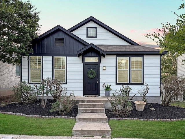 151 Campos, Kyle, TX 78640 - view of front facade with a yard and board and batten siding