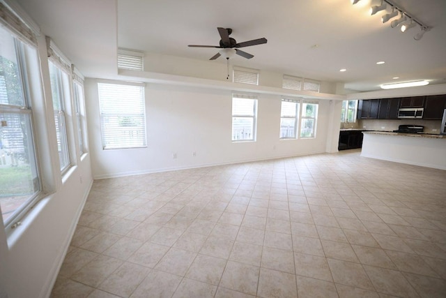 151 Campos, Kyle, TX 78640 - unfurnished living room with track lighting, healthy amount of natural light, a ceiling fan, light tile patterned floors, and recessed lighting