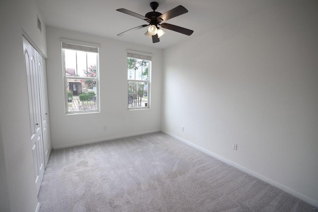 151 Campos, Kyle, TX 78640 - unfurnished bedroom with light carpet, a closet, and a ceiling fan