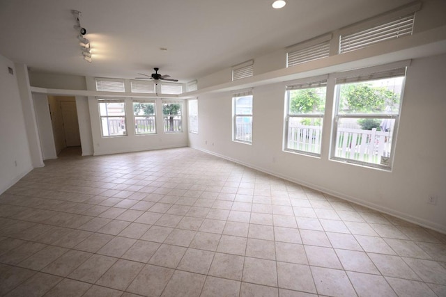 151 Campos, Kyle, TX 78640 - empty room featuring a ceiling fan, rail lighting, and light tile patterned floors