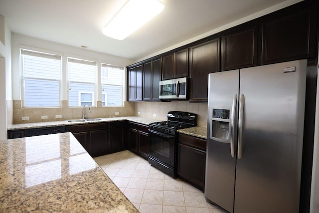 151 Campos, Kyle, TX 78640 - kitchen with stainless steel appliances, backsplash, light tile patterned floors, and light stone counters