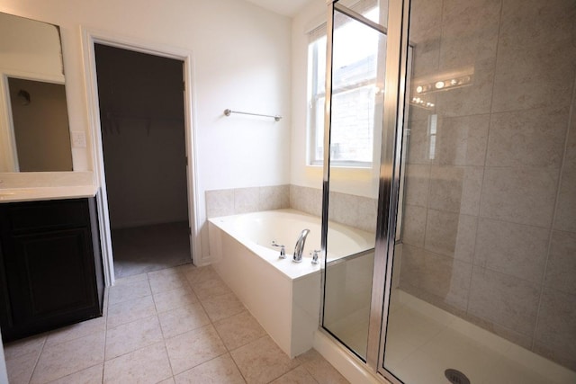 151 Campos, Kyle, TX 78640 - full bath with vanity, a stall shower, a garden tub, and tile patterned floors