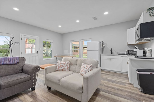 13100 N Ridge Cir, Leander, TX 78641 - living room featuring healthy amount of natural light, light wood-style flooring, and recessed lighting