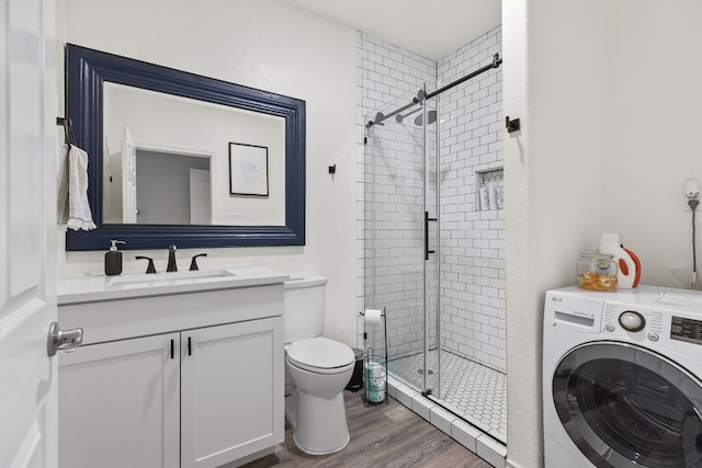 13100 N Ridge Cir, Leander, TX 78641 - full bathroom with washer / dryer, a shower stall, vanity, and wood finished floors