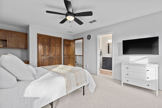 13100 N Ridge Cir, Leander, TX 78641 - bedroom with light carpet, a closet, ensuite bathroom, and ceiling fan