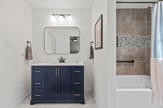 13100 N Ridge Cir, Leander, TX 78641 - full bath featuring marble finish floors, shower / bath combo with shower curtain, vanity, and a ceiling fan