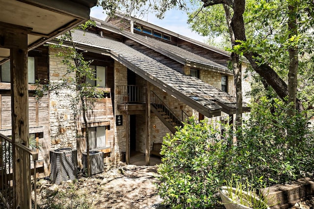 8200 Neely Dr Unit 119, Austin, TX 78759 - rear view of house featuring stone siding and stairway