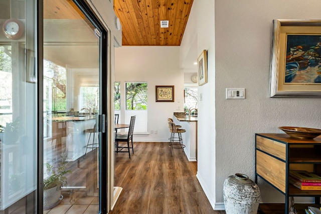 8200 Neely Dr Unit 119, Austin, TX 78759 - hallway featuring plenty of natural light, wooden ceiling, a textured wall, and dark wood-style flooring
