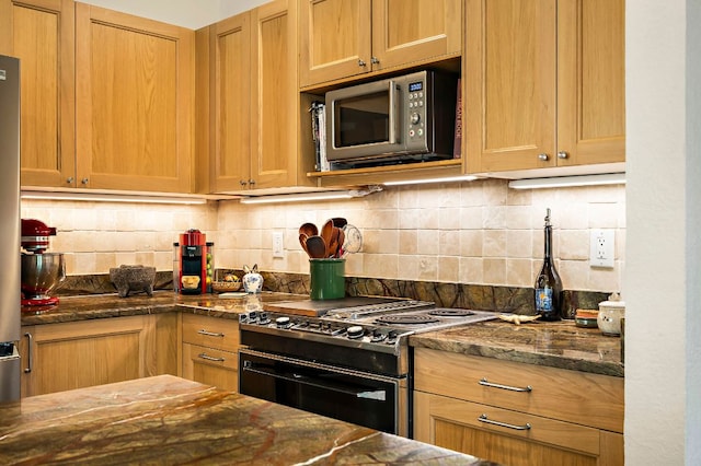 8200 Neely Dr Unit 119, Austin, TX 78759 - kitchen with appliances with stainless steel finishes, decorative backsplash, and dark stone counters