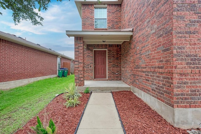 3417 Tralagon Trl, Pflugerville, TX 78660 - view of exterior entry featuring brick siding and a yard