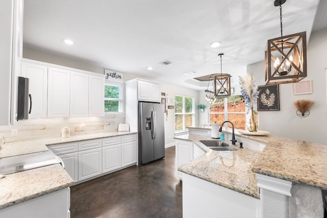 102 Moku Ct, Bastrop, TX 78602 - kitchen featuring stainless steel fridge with ice dispenser, recessed lighting, white cabinetry, finished concrete flooring, and a chandelier