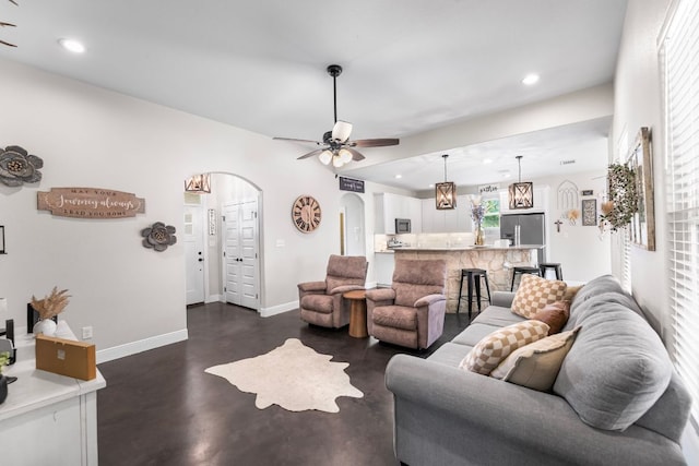102 Moku Ct, Bastrop, TX 78602 - living room with arched walkways, concrete flooring, recessed lighting, and a ceiling fan