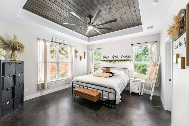 102 Moku Ct, Bastrop, TX 78602 - bedroom with a raised ceiling, finished concrete floors, multiple windows, wooden ceiling, and a ceiling fan