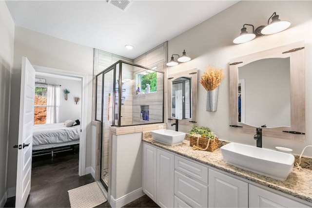102 Moku Ct, Bastrop, TX 78602 - ensuite bathroom featuring a stall shower, double vanity, and finished concrete floors